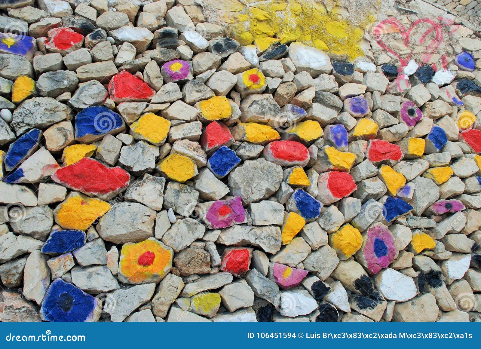 amazing coloured stones wall: blue, yellow, red, black, grey, violet.