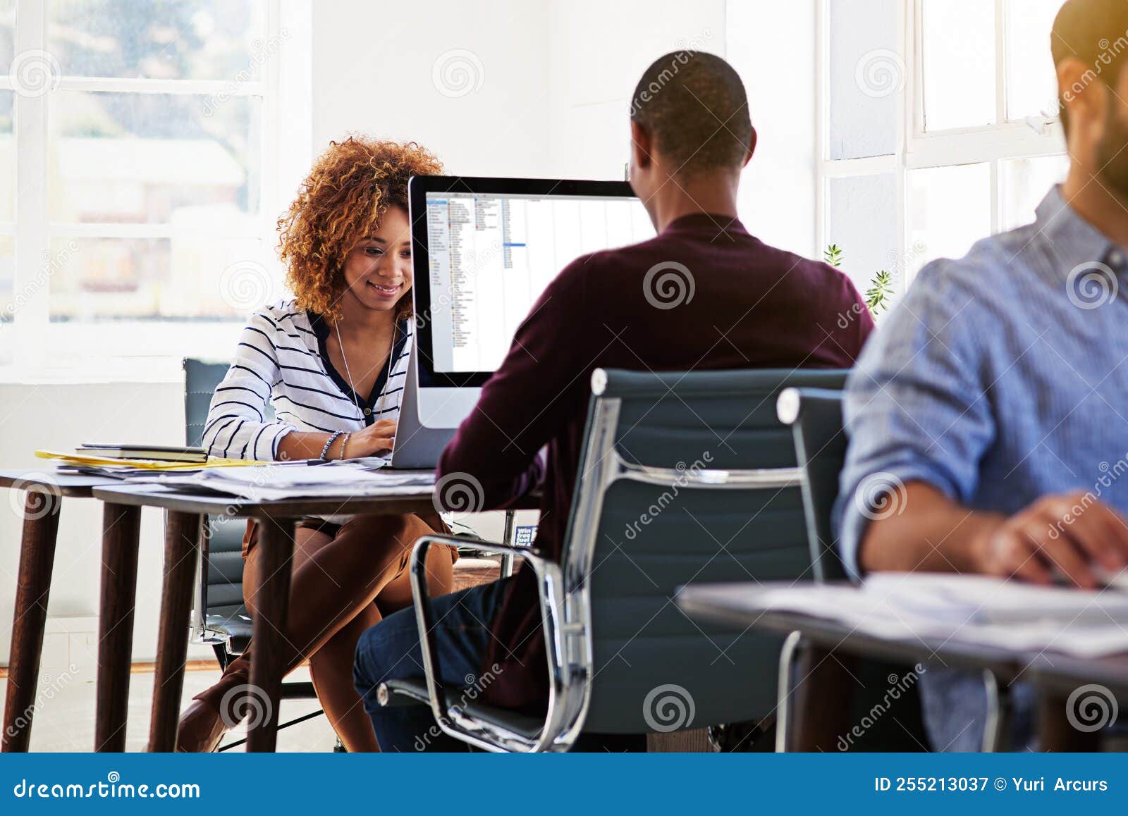 Hard at Work in the Office. Colleagues Working on Their Computers in an
