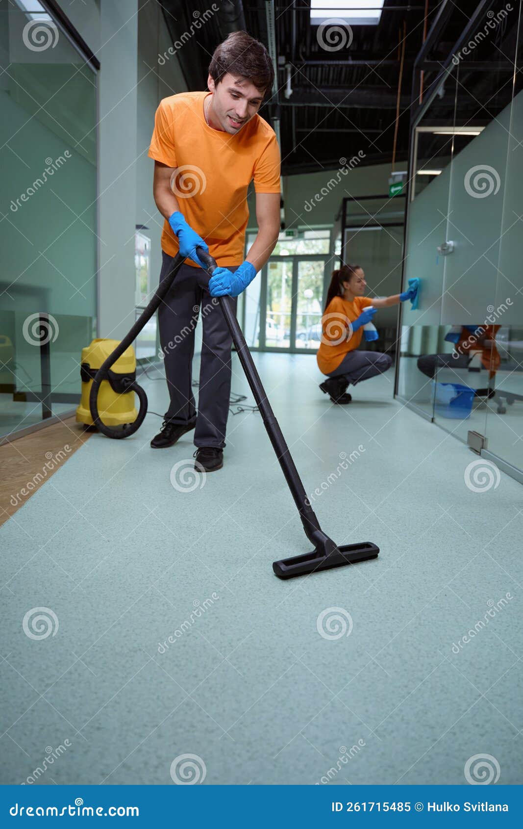 hard-working man in uniform tidying the floor in the building