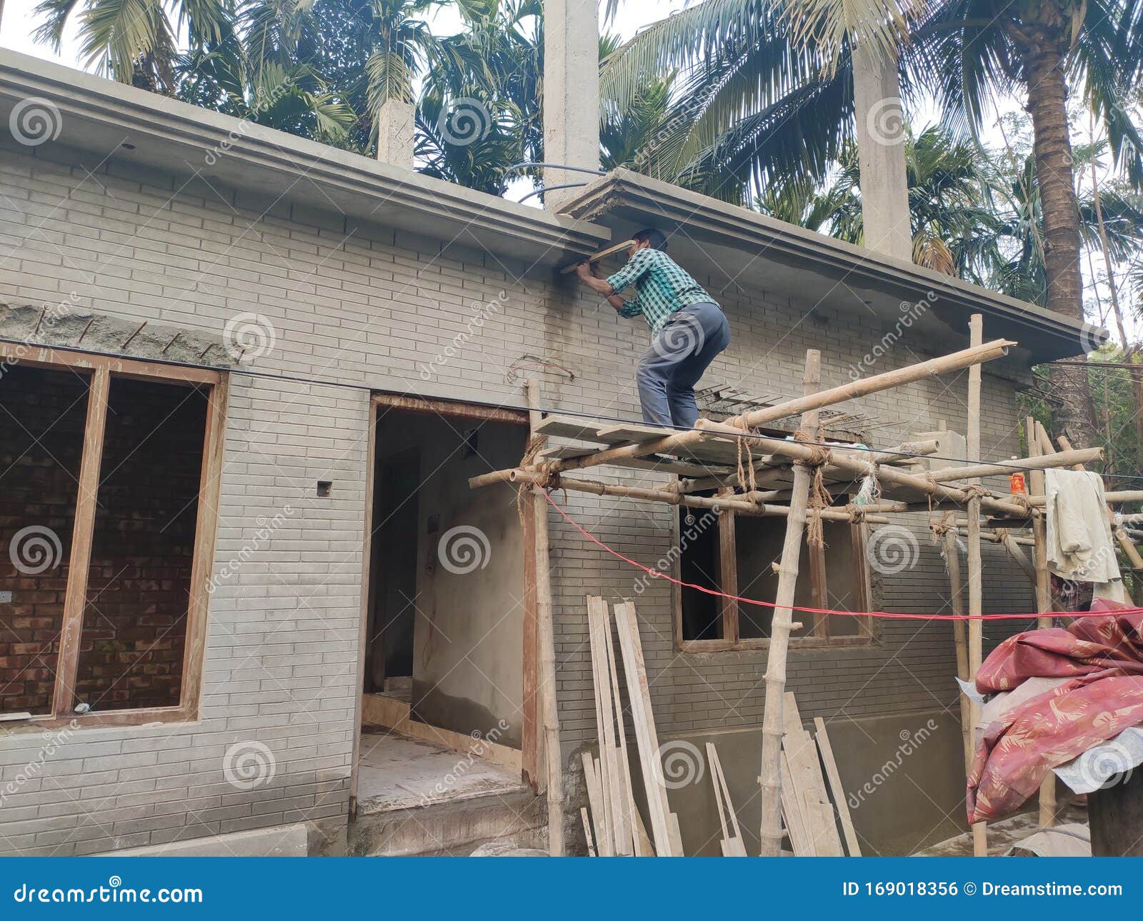 A Hard Working Worker is Building a House in India Editorial Photo
