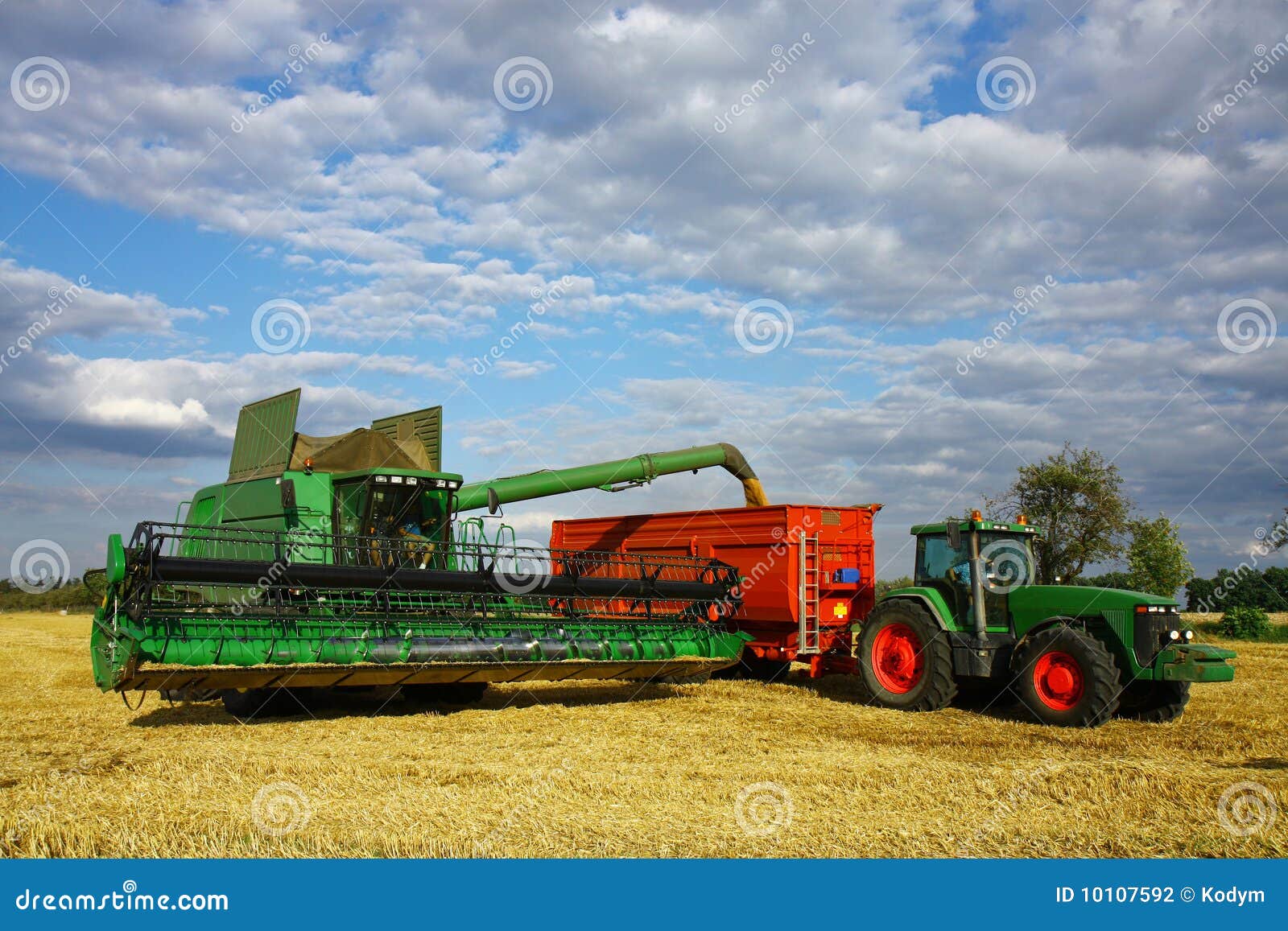 Harvester load the trailer stock photo. Image of clouds 10107592