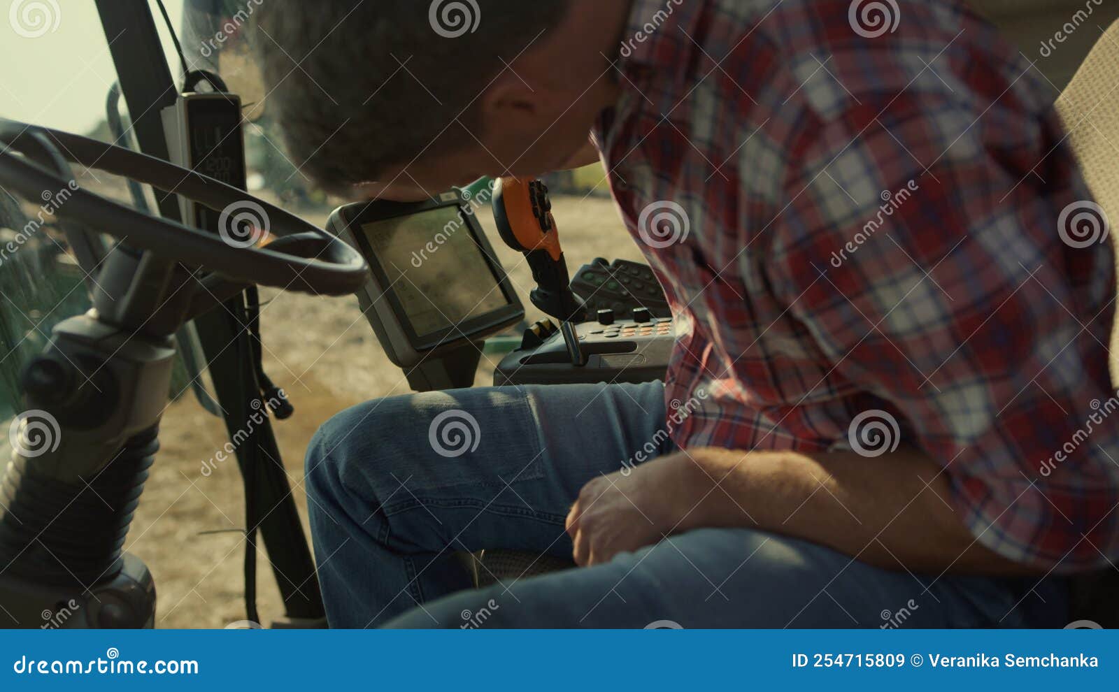 Harvester Operator Checking Machine Display Closeup. Tractor Driver