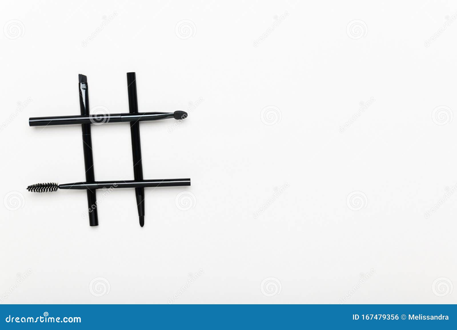 Hashtag Made of Mascara and Eyeshadow Brushes on White Background