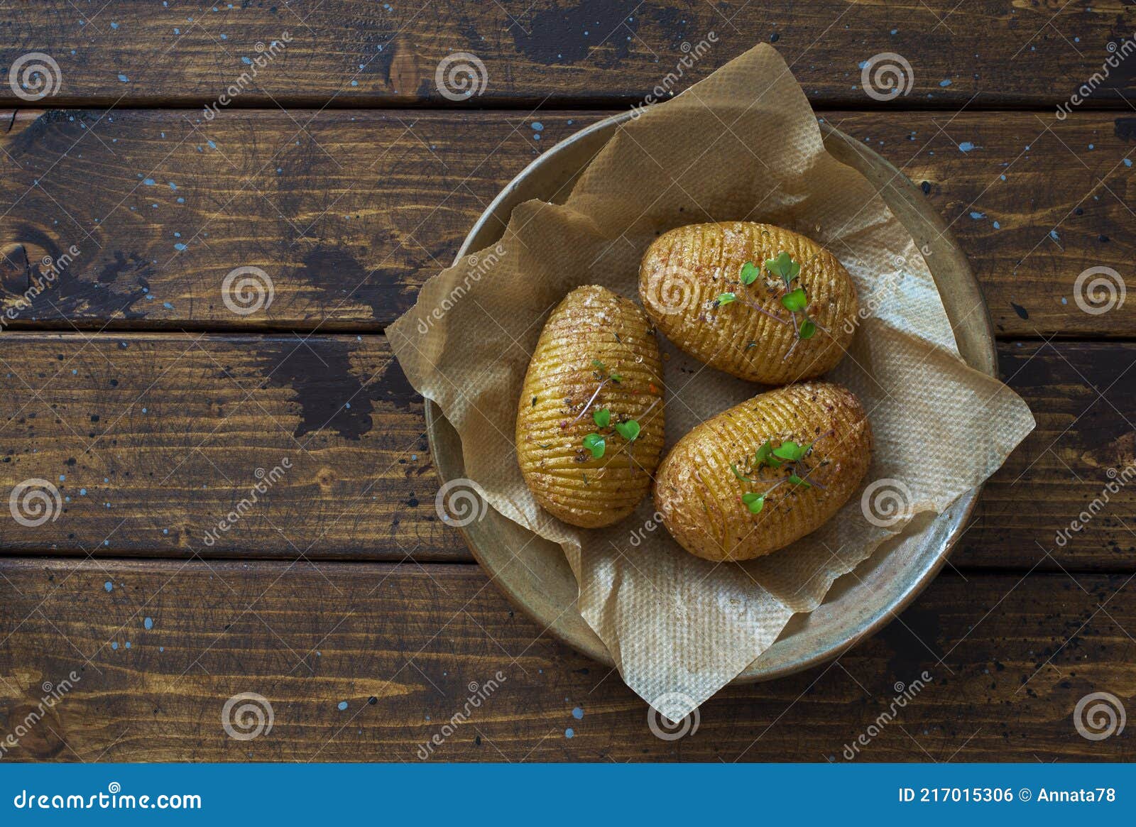 hasselblad potatoes oven  baked with spices and olive oil on dark wooden table