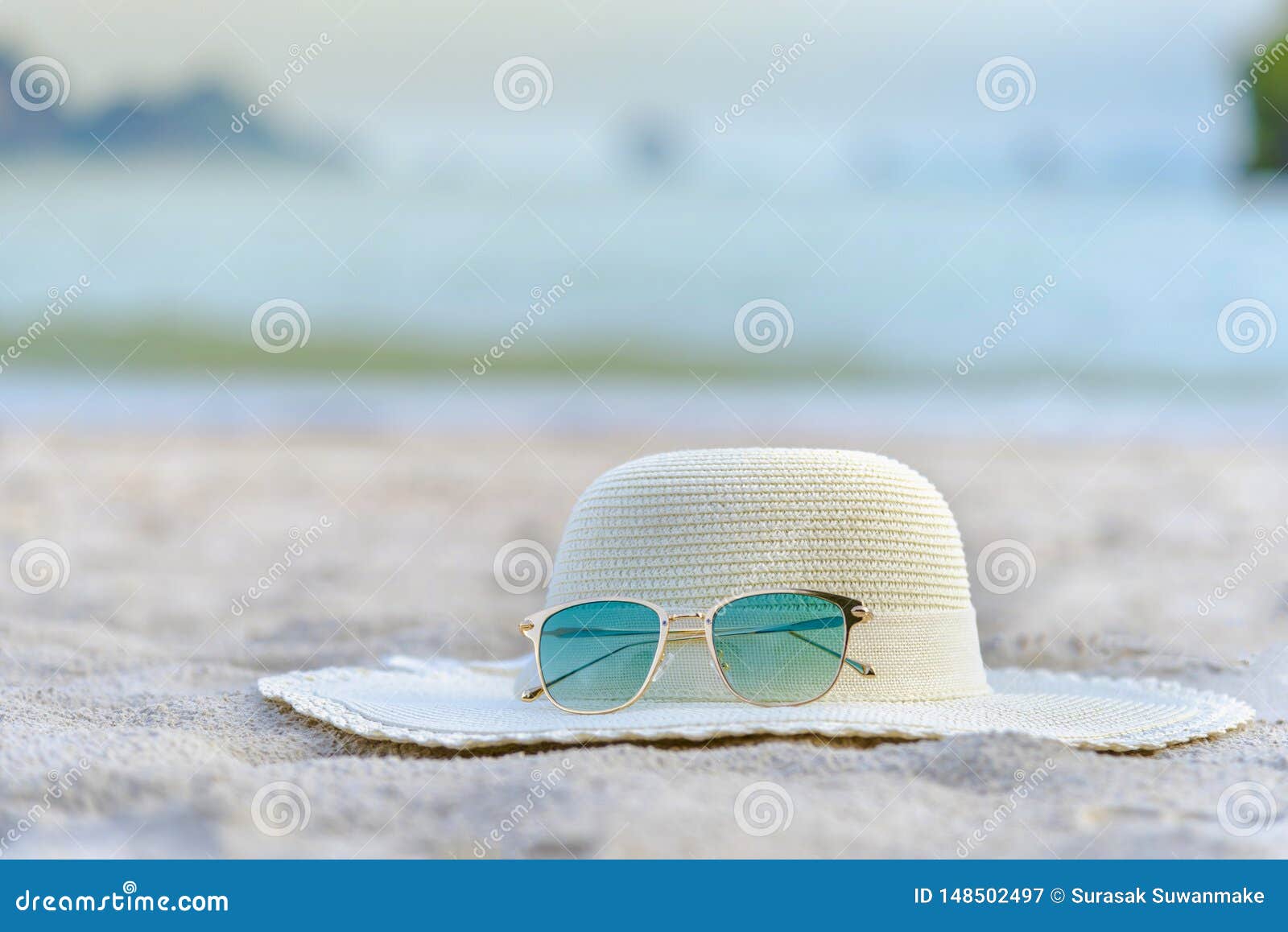 Hats and Glasses are Located on the Beach, Blue Sea, during the Day of ...