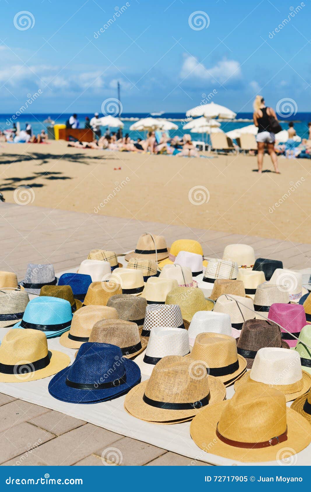 hats on sale at la barceloneta beach in barcelona, spain