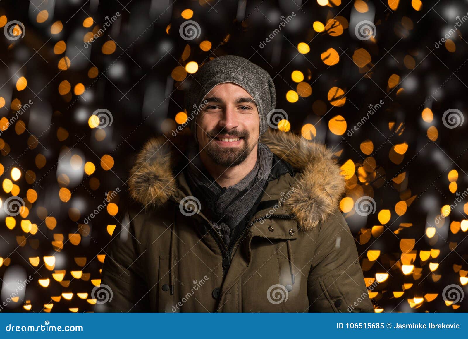 Having Fun at a Christmas Fairy Young Cheerful Man Dressed Warm Is Standing In Holiday Market