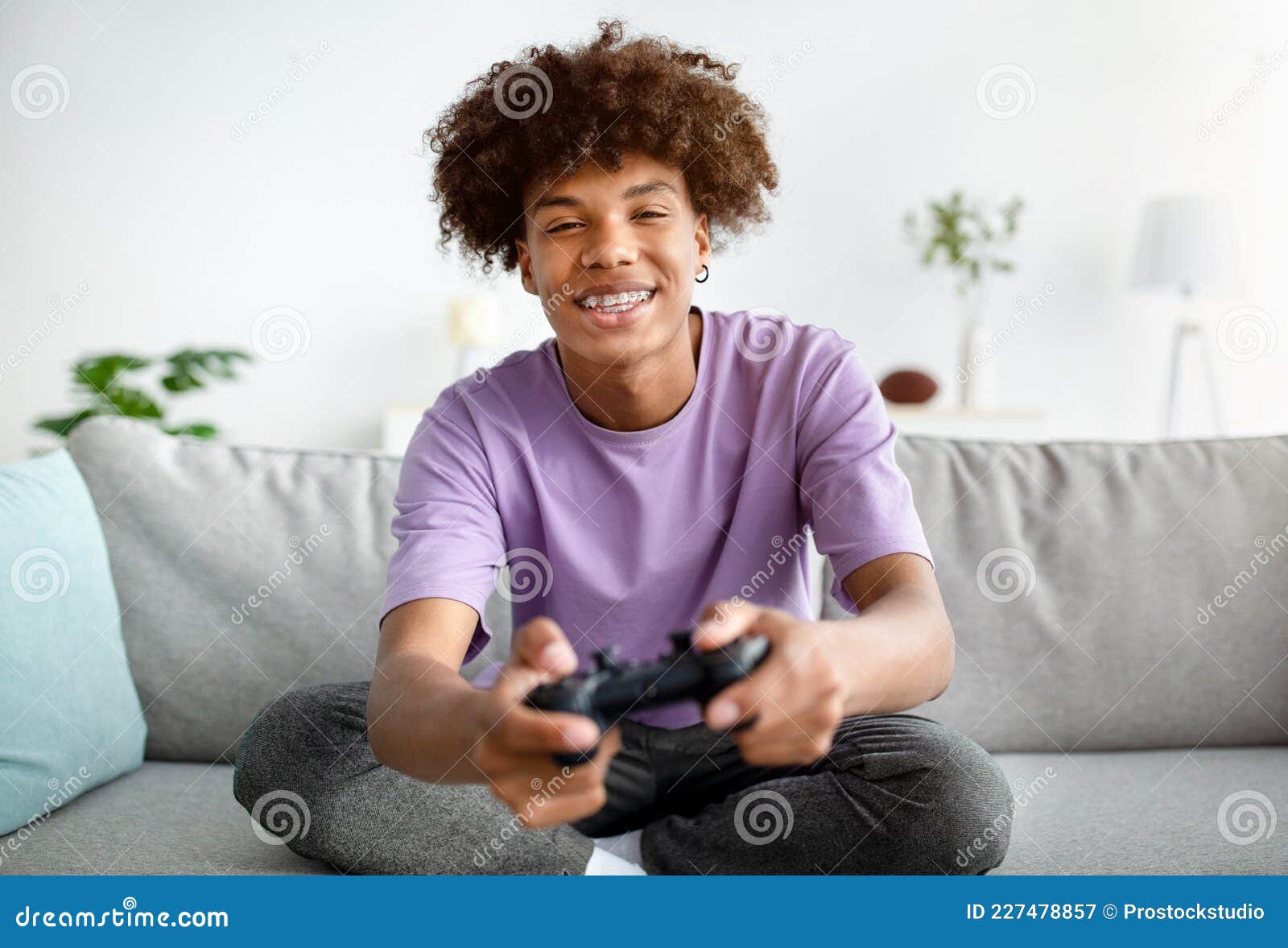 Having Fun at Home. Cheerful Black Teen Guy with Joystick Playing Online  Computer Games, Sitting on Couch Indoors Stock Image - Image of computer,  person: 227478857