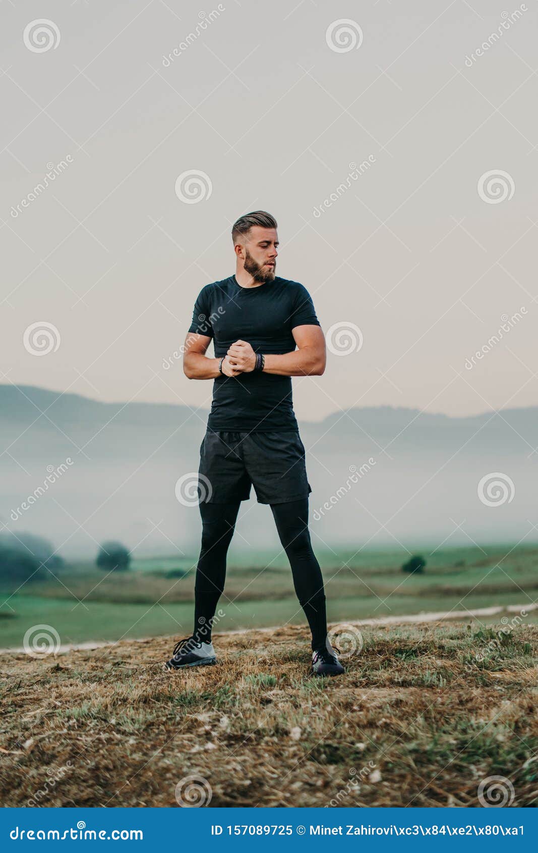 Having a Good Stretch. Handsome Young Man in Sports Clothing Stretching ...