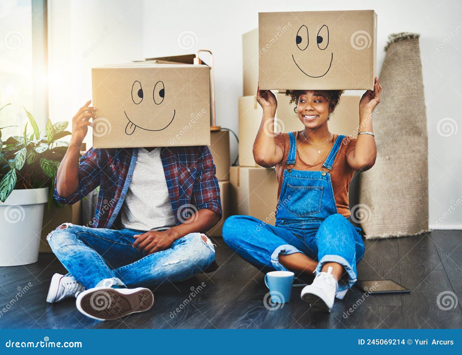 Having Some Moving in Fun. Shot of a Young Couple Moving House. Stock