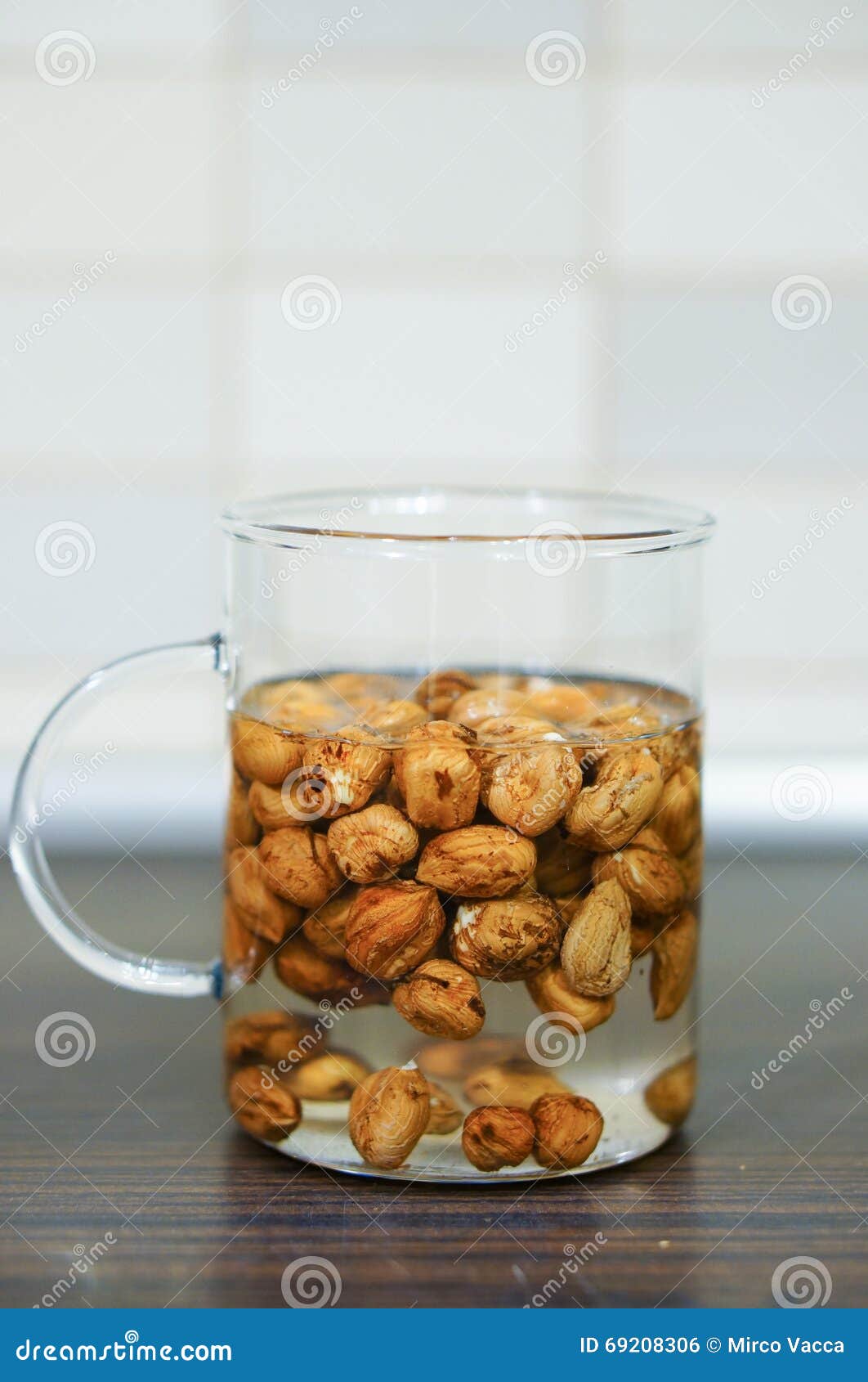 Hazelnuts in water stock photo. Image of water, snack 69208306