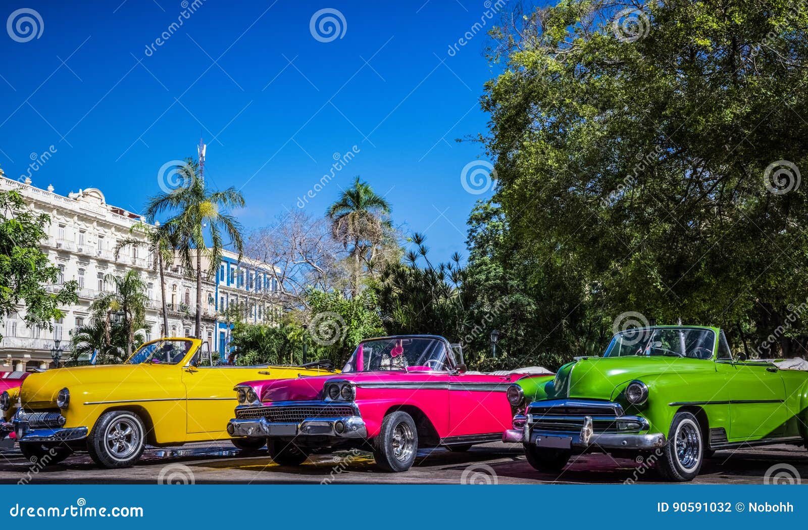 hdr - beautiful american convertible vintage cars parked in series in havana cuba before the gran teatro - serie cuba reportage