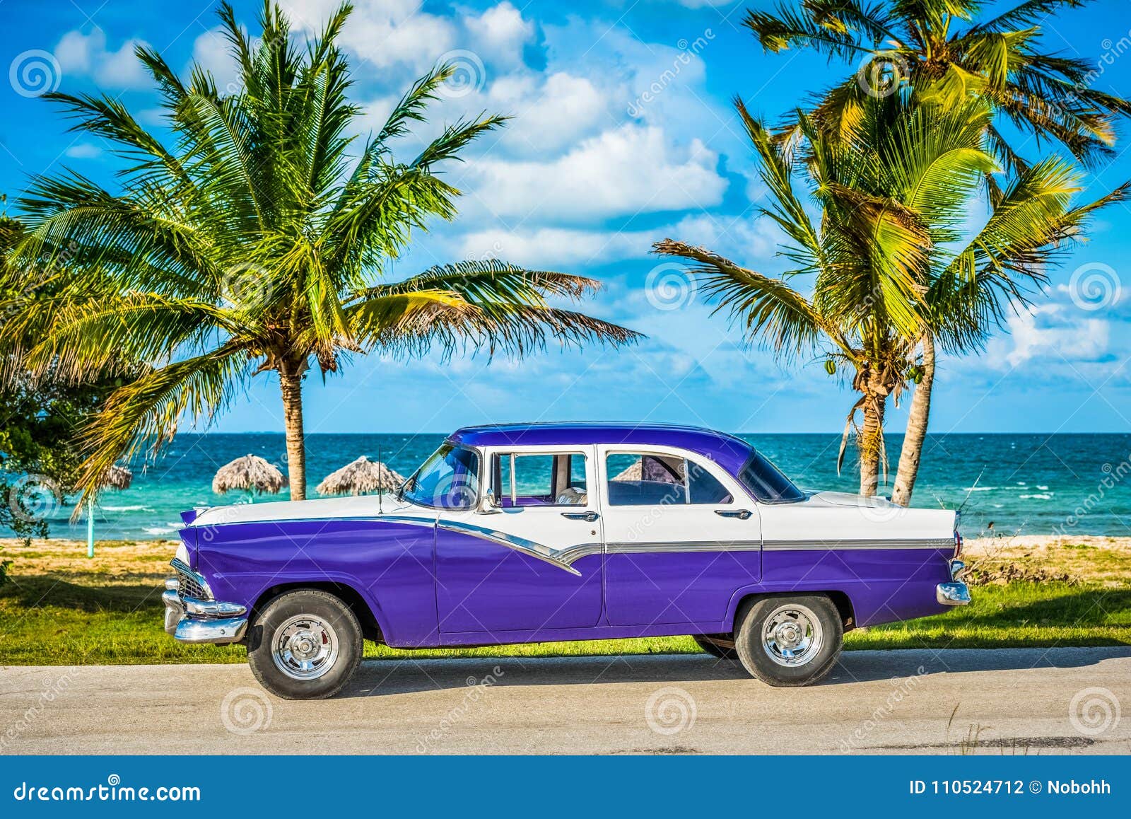 hdr - parked american white blue vintage car in the front-side view on the beach in havana cuba - serie cuba reportage