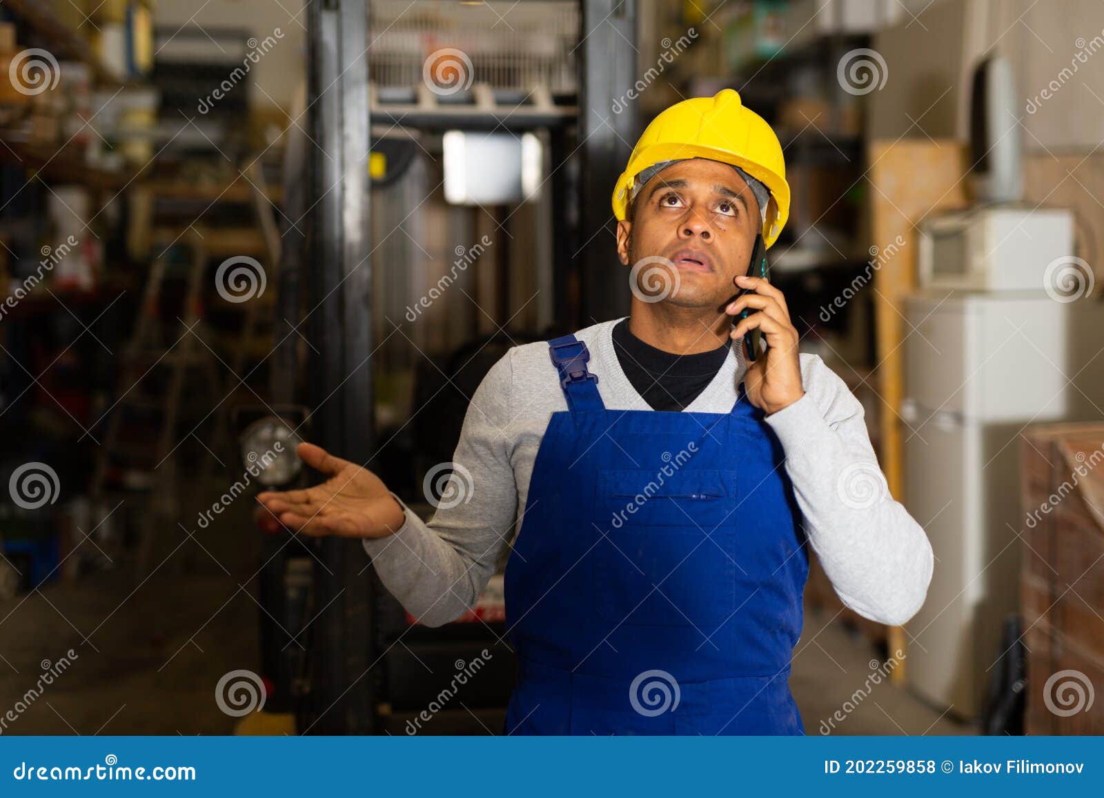 Head of Construction Store Talking on Mobile Phone in Warehouse Stock