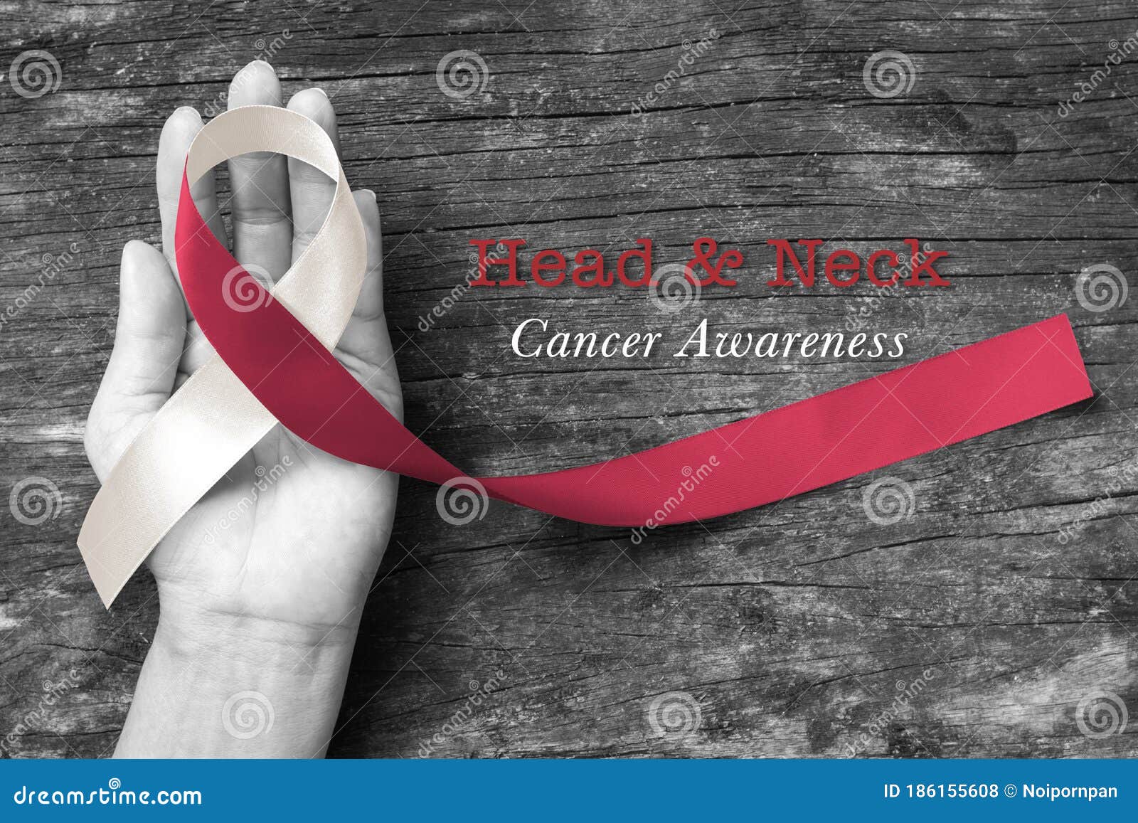 head and neck cancer awareness with ic burgundy ivory white ribbon on hand and old aged wood