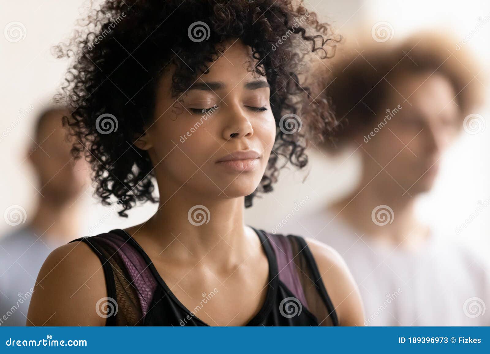 young peaceful african american woman enjoying deep meditation.