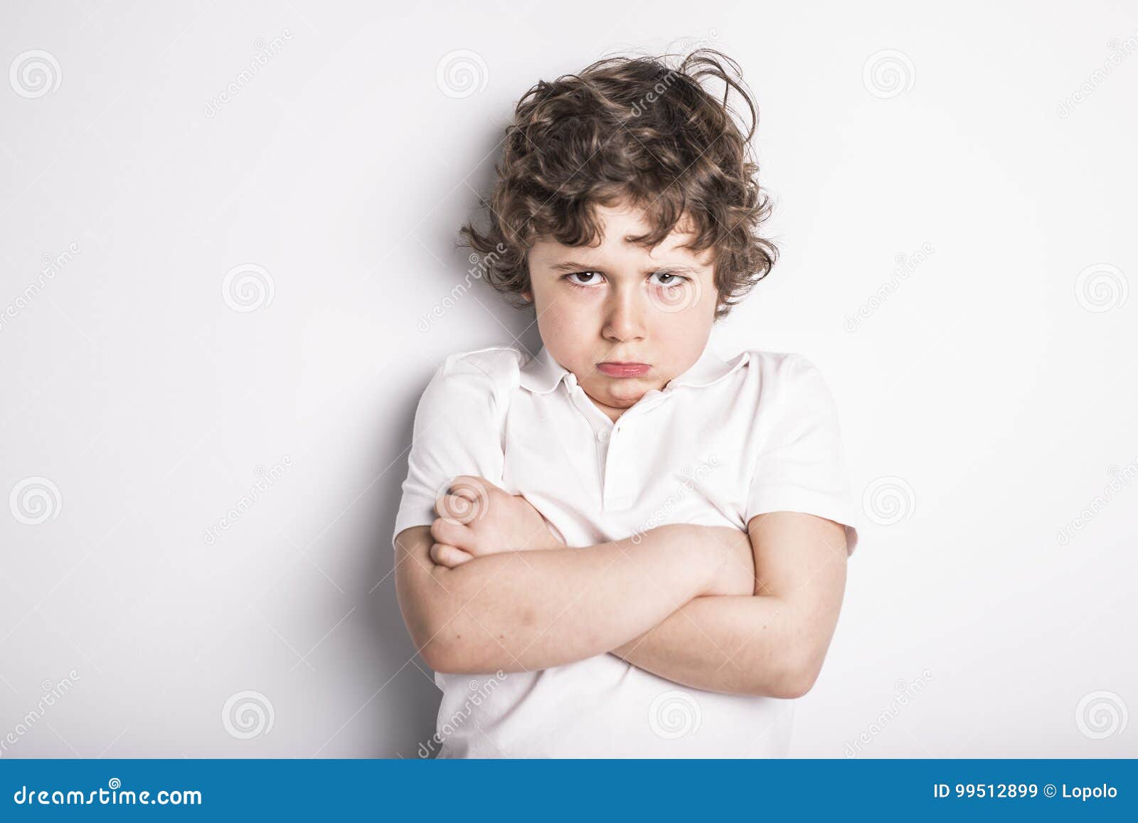 head and shoulders close up portrait of young boy with sulk attitude