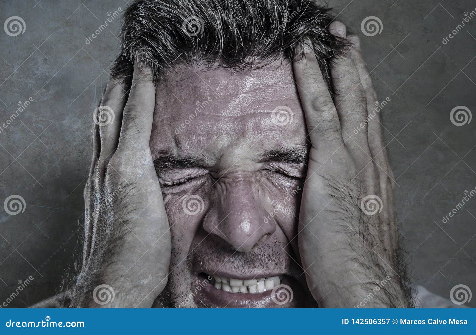 Head and Shoulders Dramatic Portrait of Young Man Crying in Pain