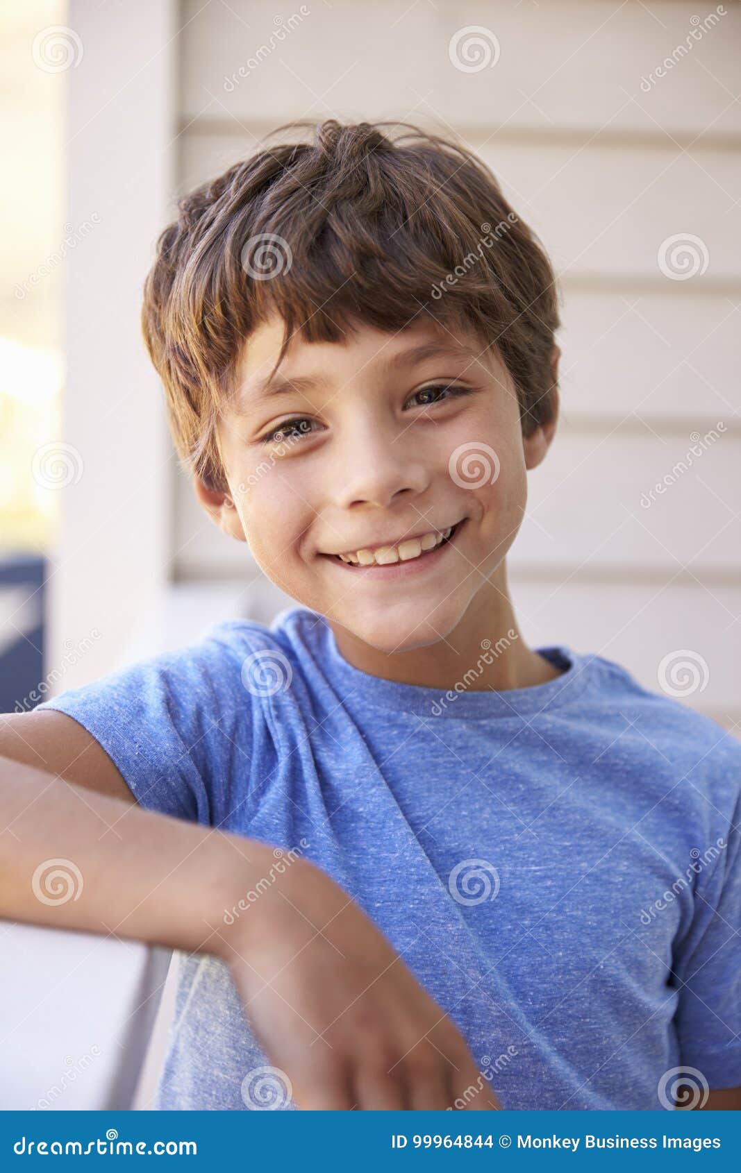 Head And Shoulders Portrait Of Boy Outside House Stock Photo Image Of