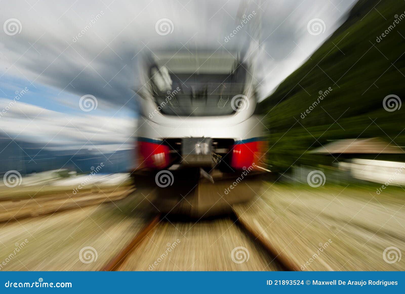Head on view of fast train on railway track with slow motion blur.