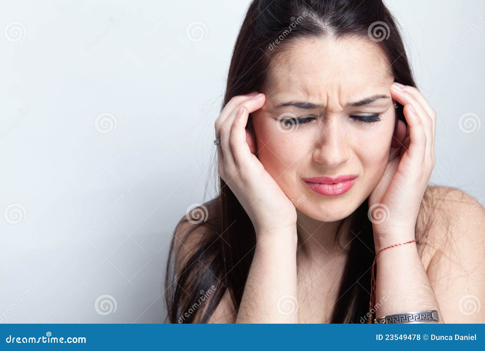 headache concept - woman suffering a migraine