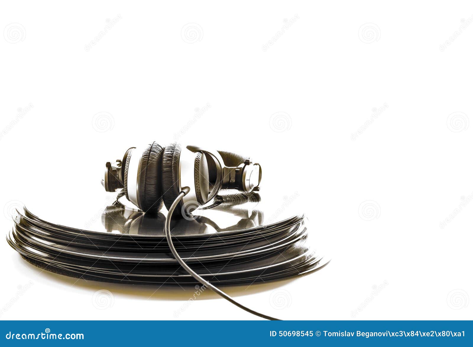headphones lying on the stack of vinyl records.