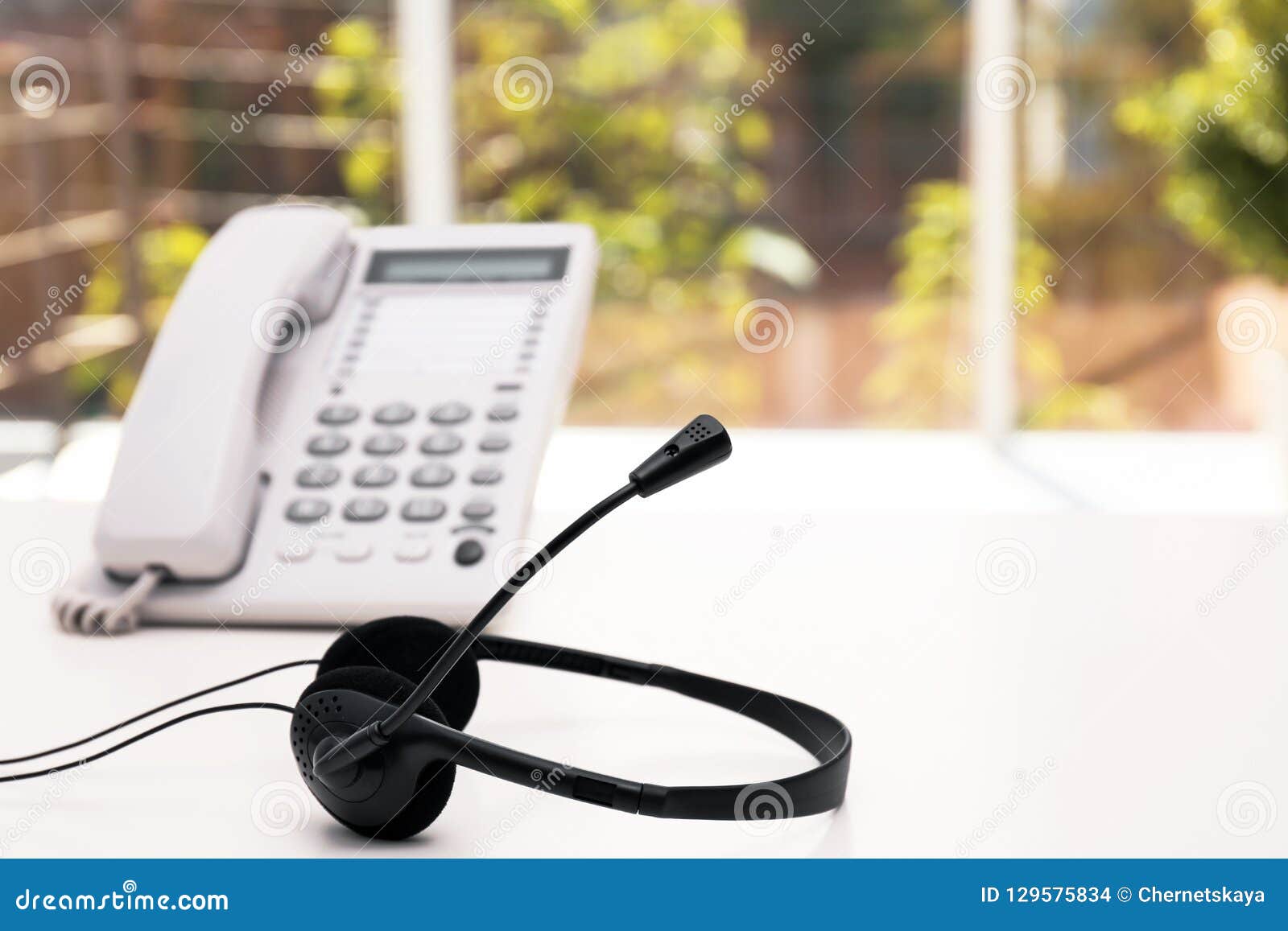 Headset And Desk Phone On Table Space For Text Stock Photo