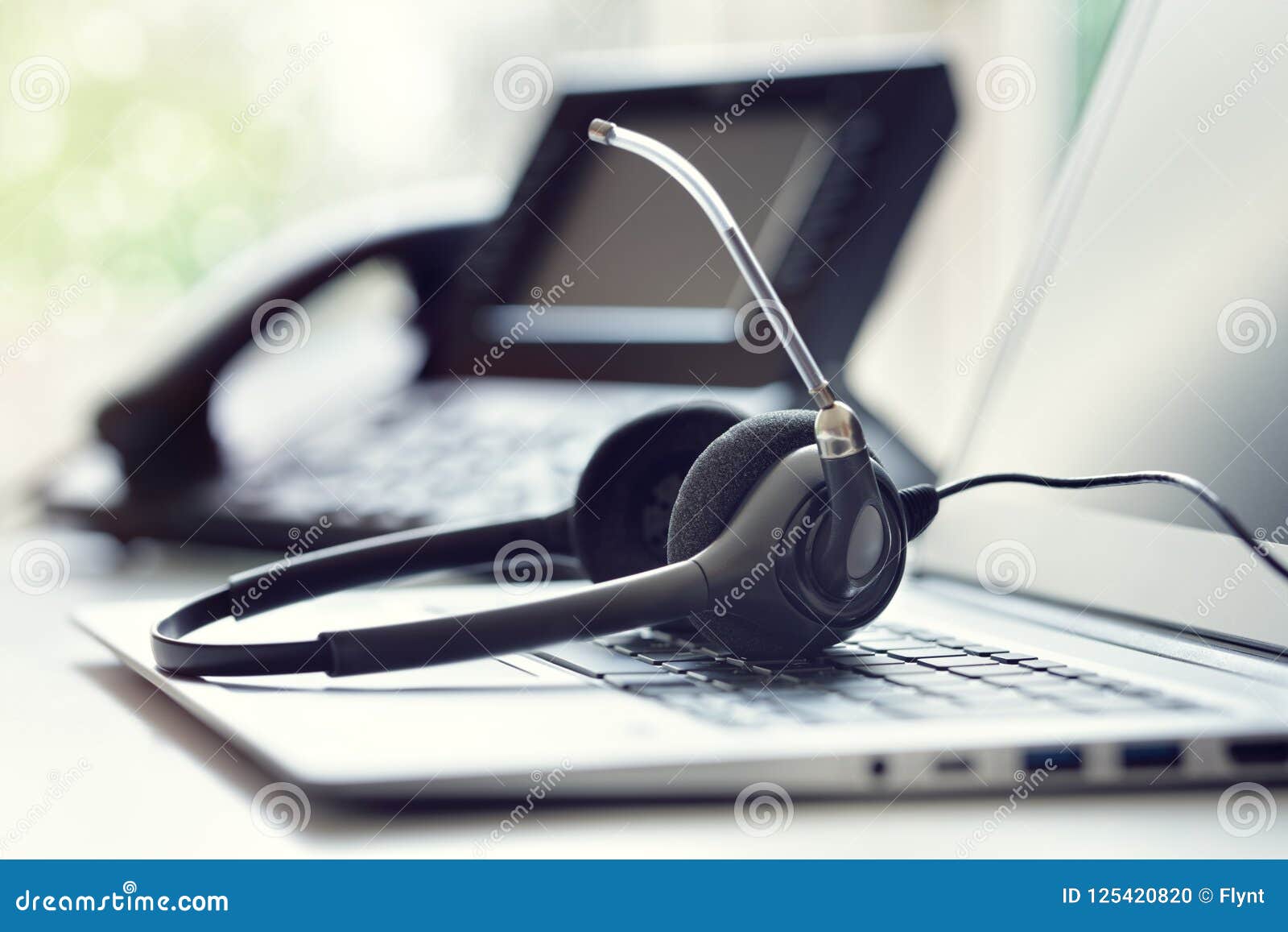 headset headphones telephone and laptop in call center