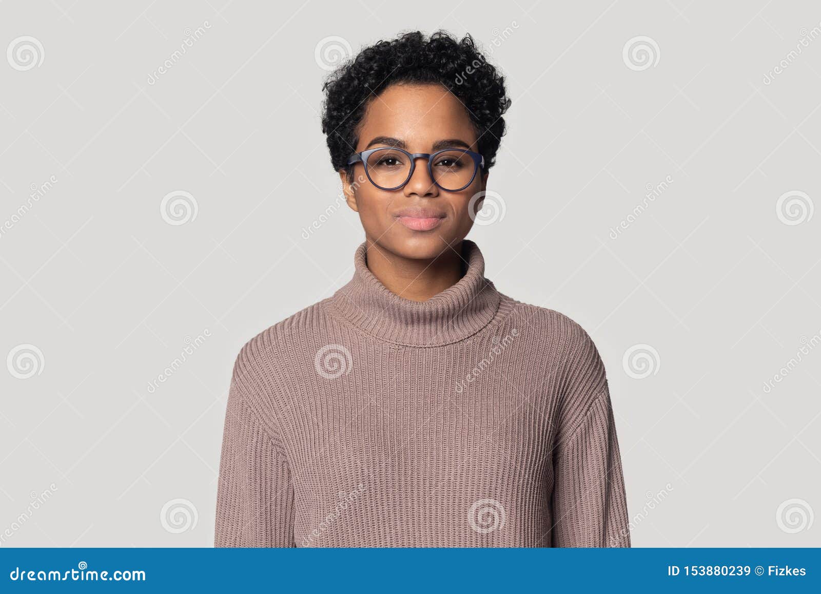 headshot of black woman in glasses posing  in studio