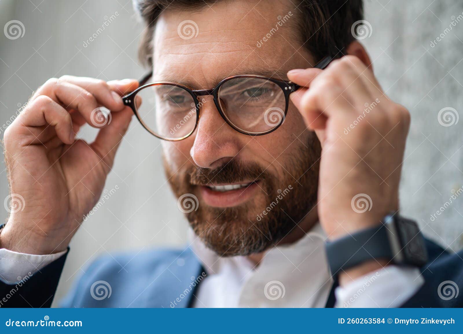 Headshot of a Man Putting on Eyeglasses Stock Photo Image of