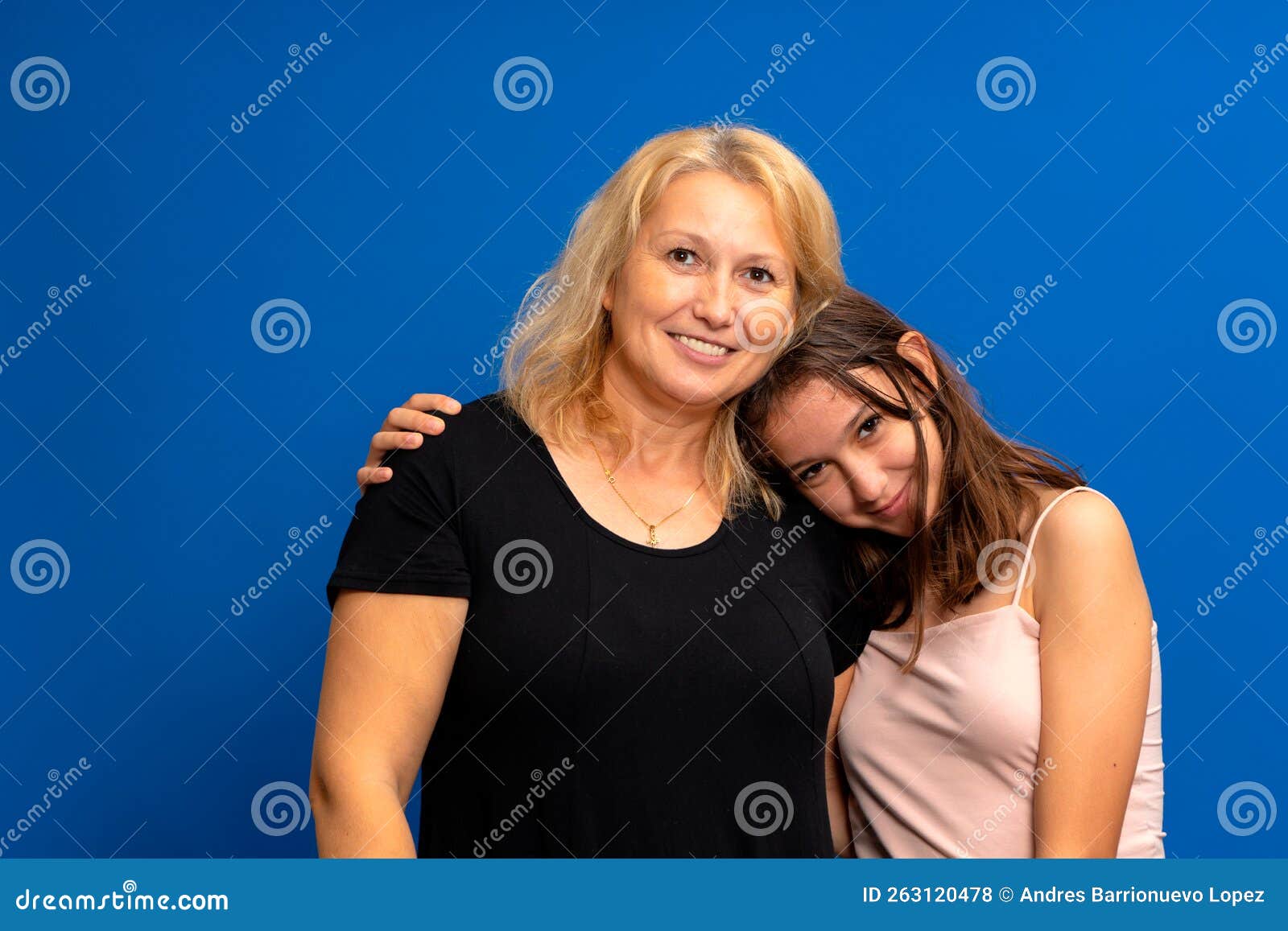 headshot portrait of a smiling multiracial family of different female generations. happy caucasian mother in her 40s