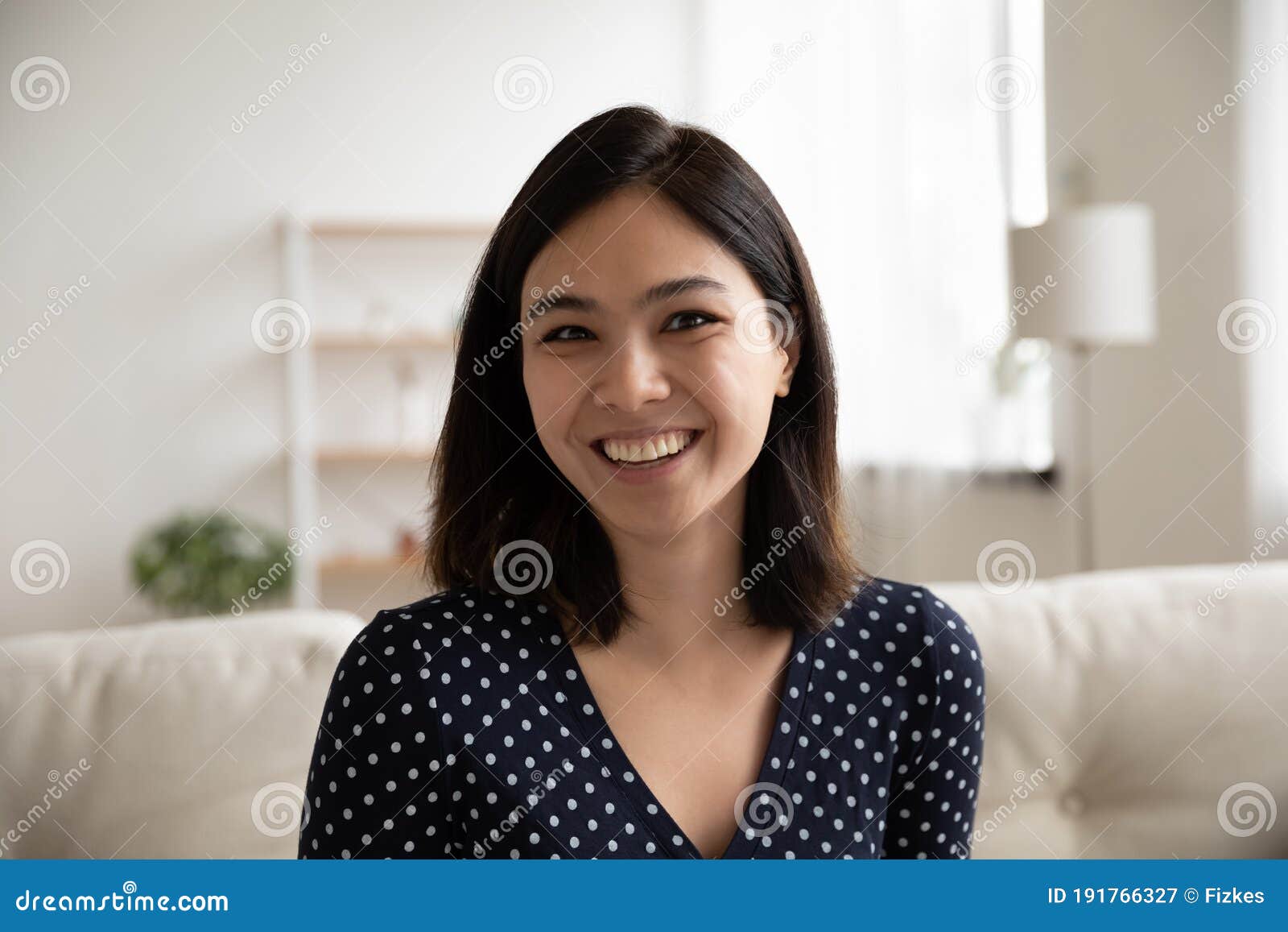 headshot of smiling asian girl talk on video call