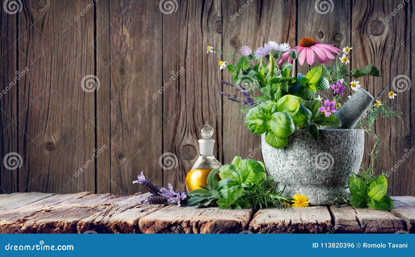 healing herbs and essential oil in bottle with mortar