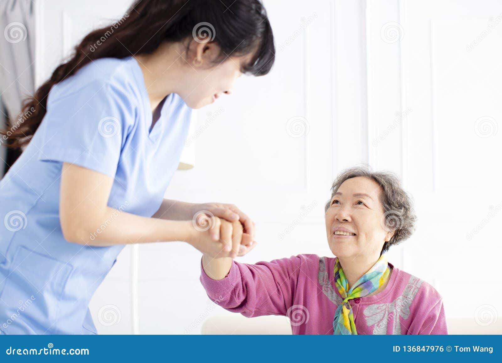 health visitor and a senior woman during home visit