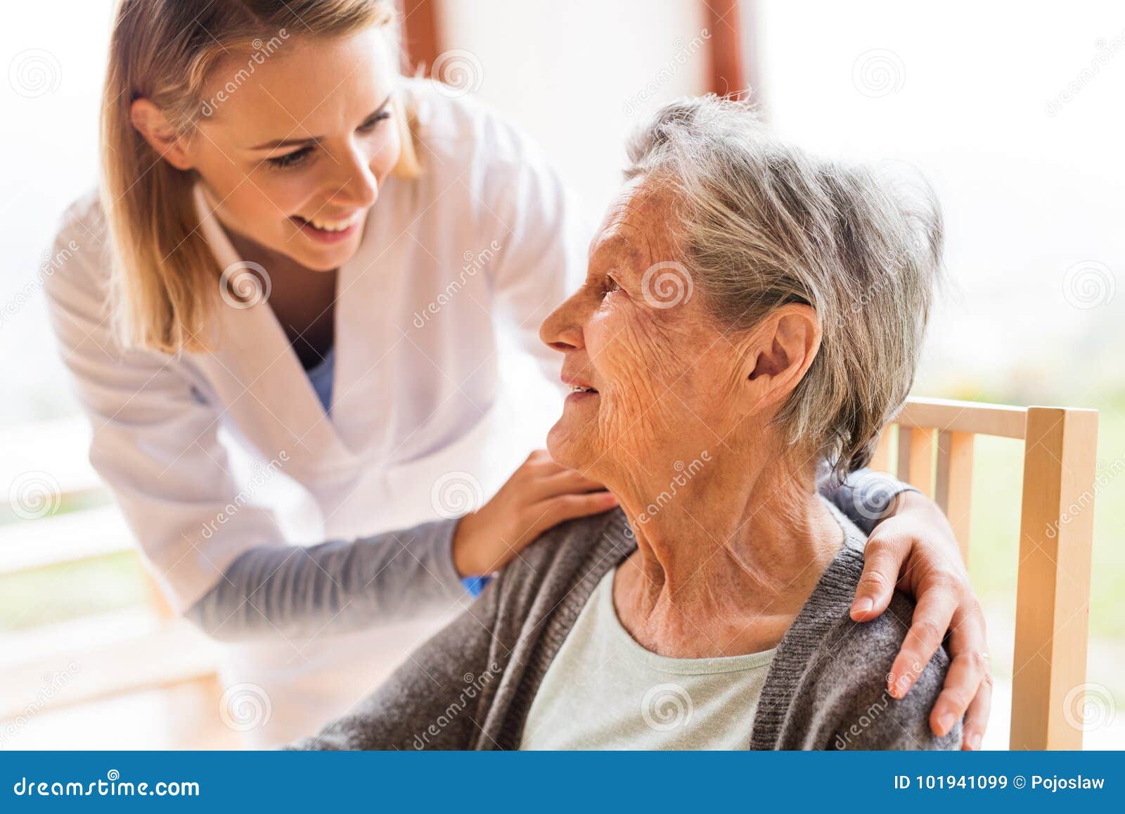 health visitor and a senior woman during home visit.