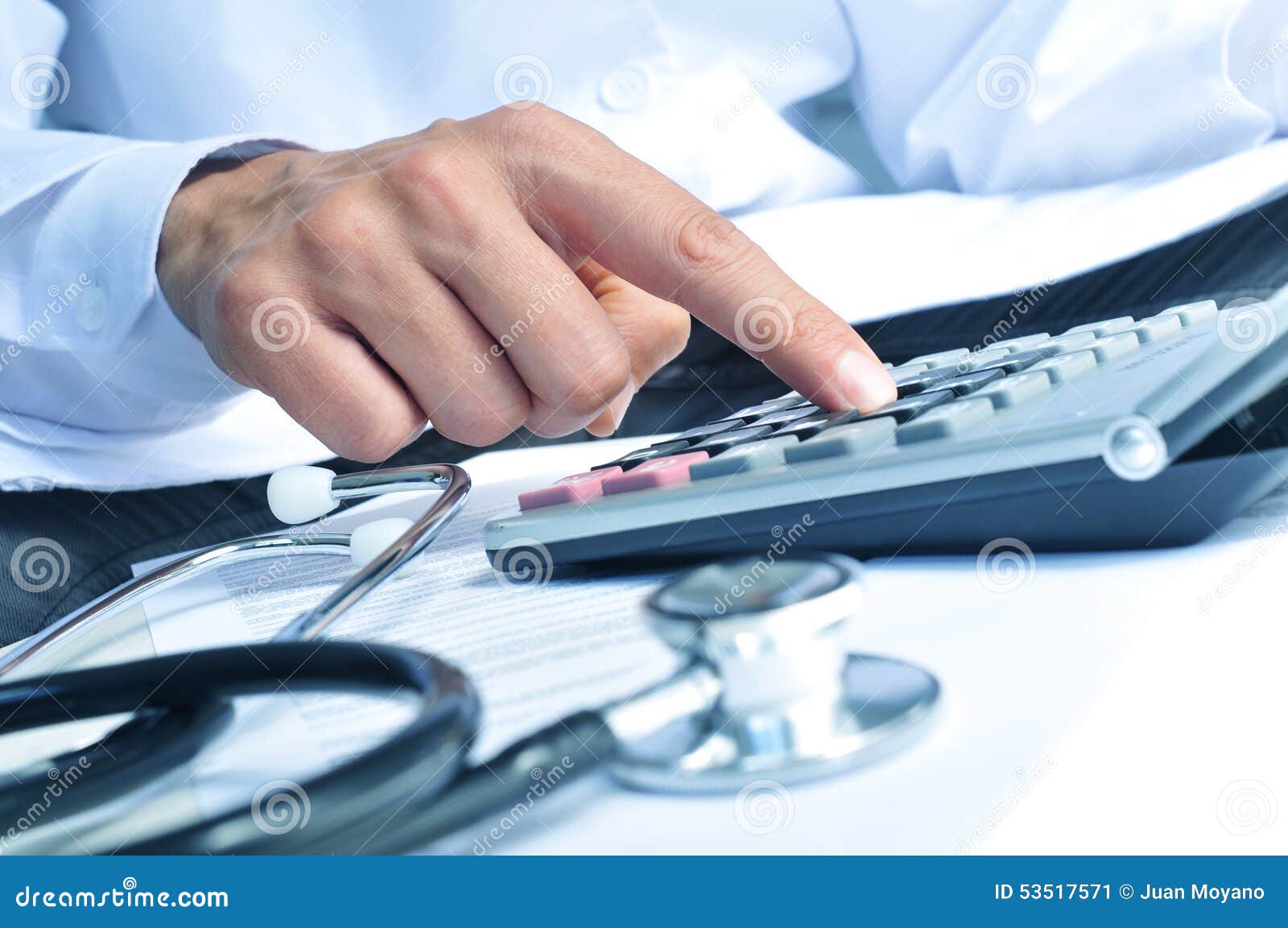 healthcare professional calculating on an electronic calculator