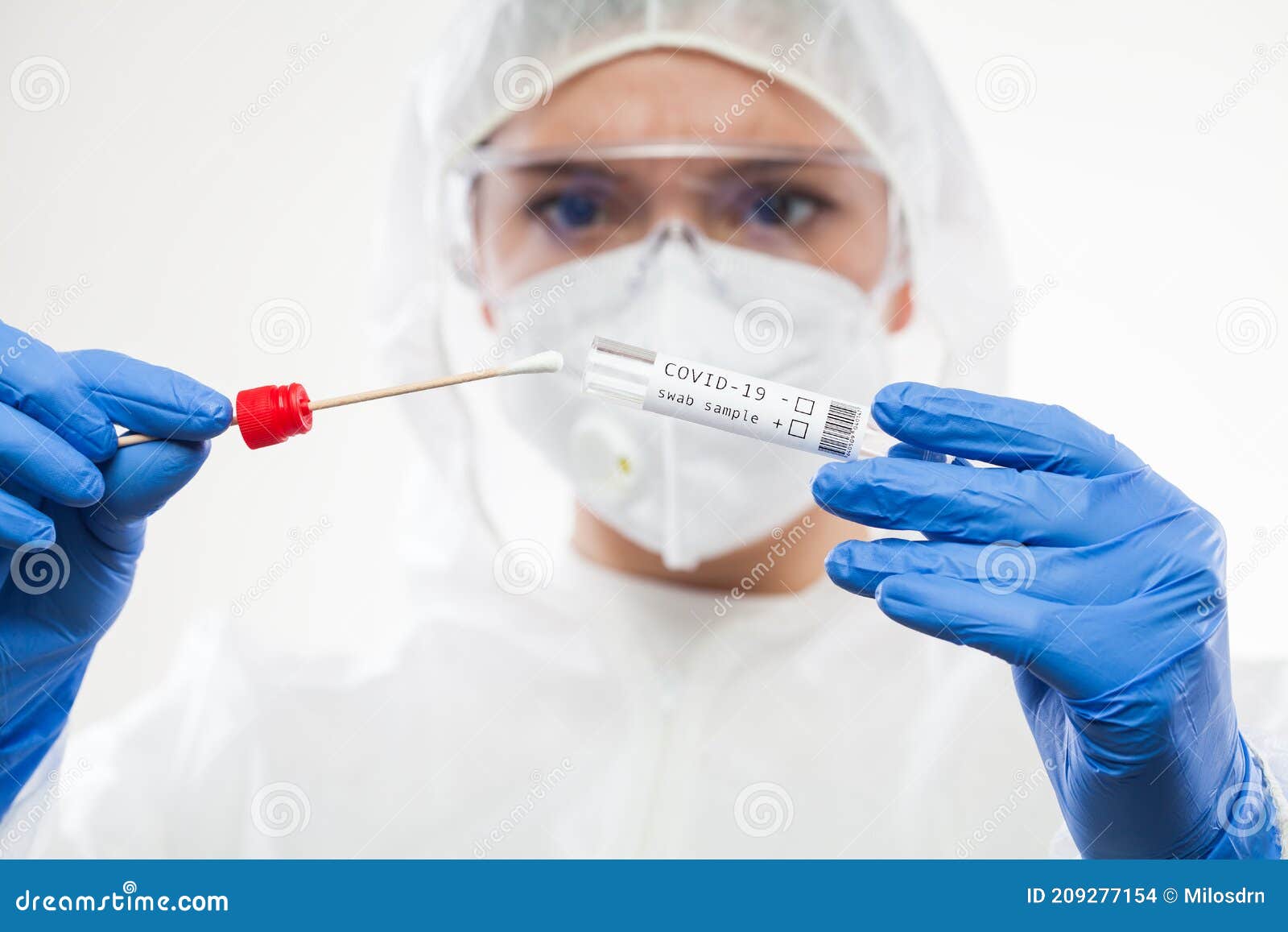 healthcare professional holding coronavirus covid-19 test kit equipment