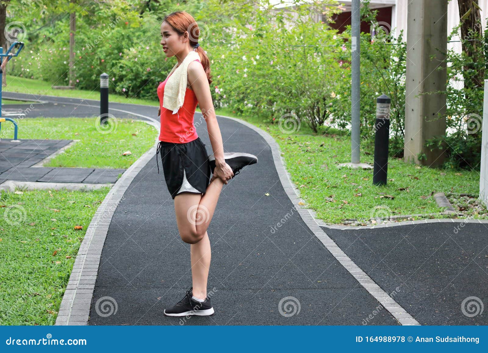 Healthy Asian Woman Stretching Her Legs Before Run In Park Fitness And 