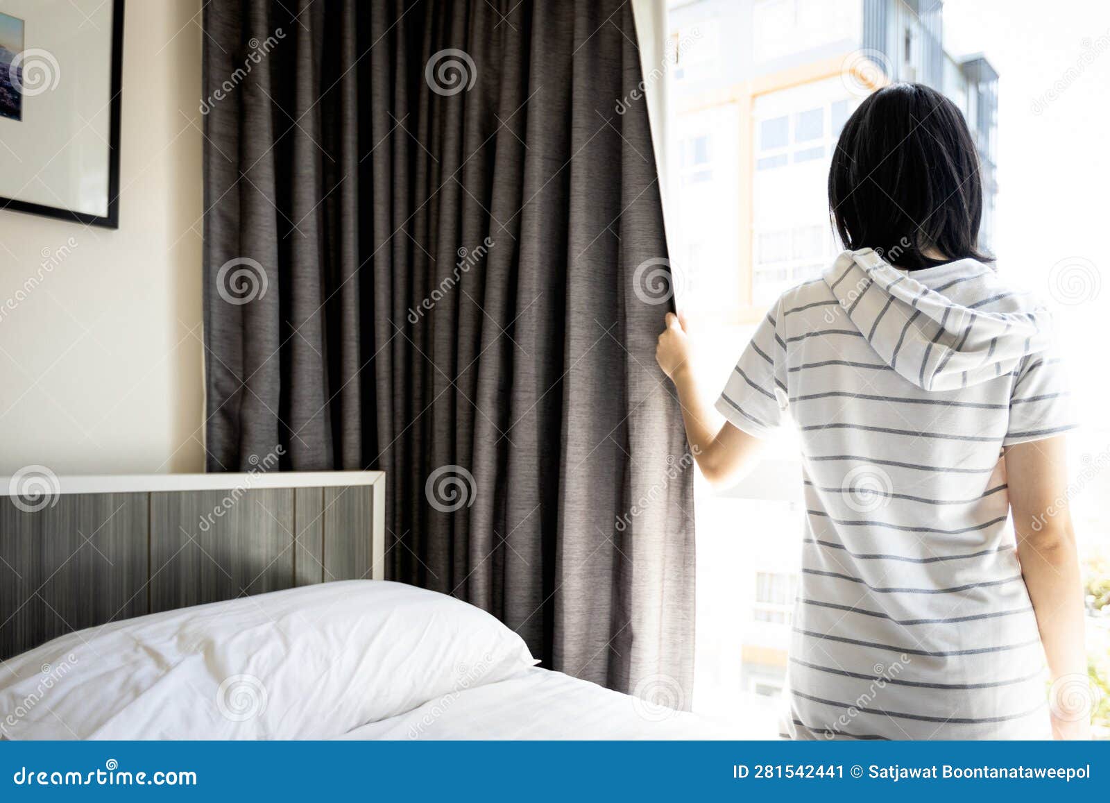 healthy asian young woman opening curtains and windows for hygienic,sunlight to enter her bedroom and air circulate freely in room