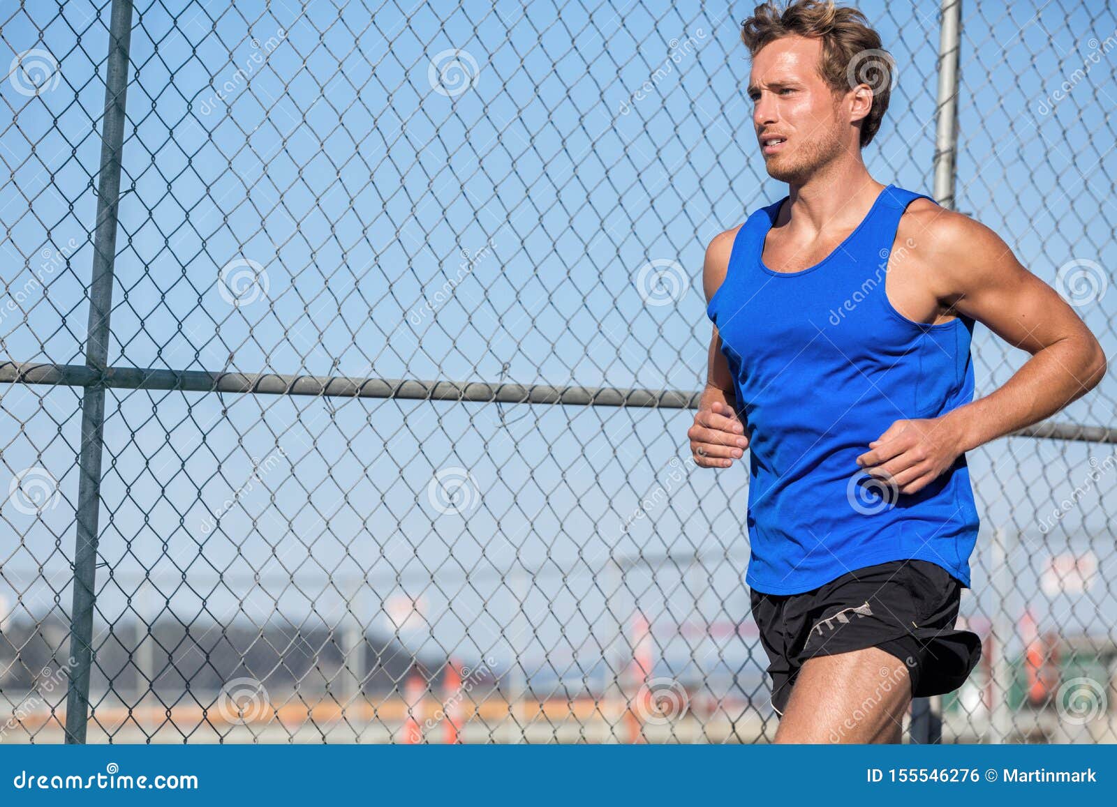 healthy-athlete-runner-man-urban-city-lifestyle-young-sports-male-running-grunge-fence-background-outdoors-summer-wearing-blue-155546276.jpg