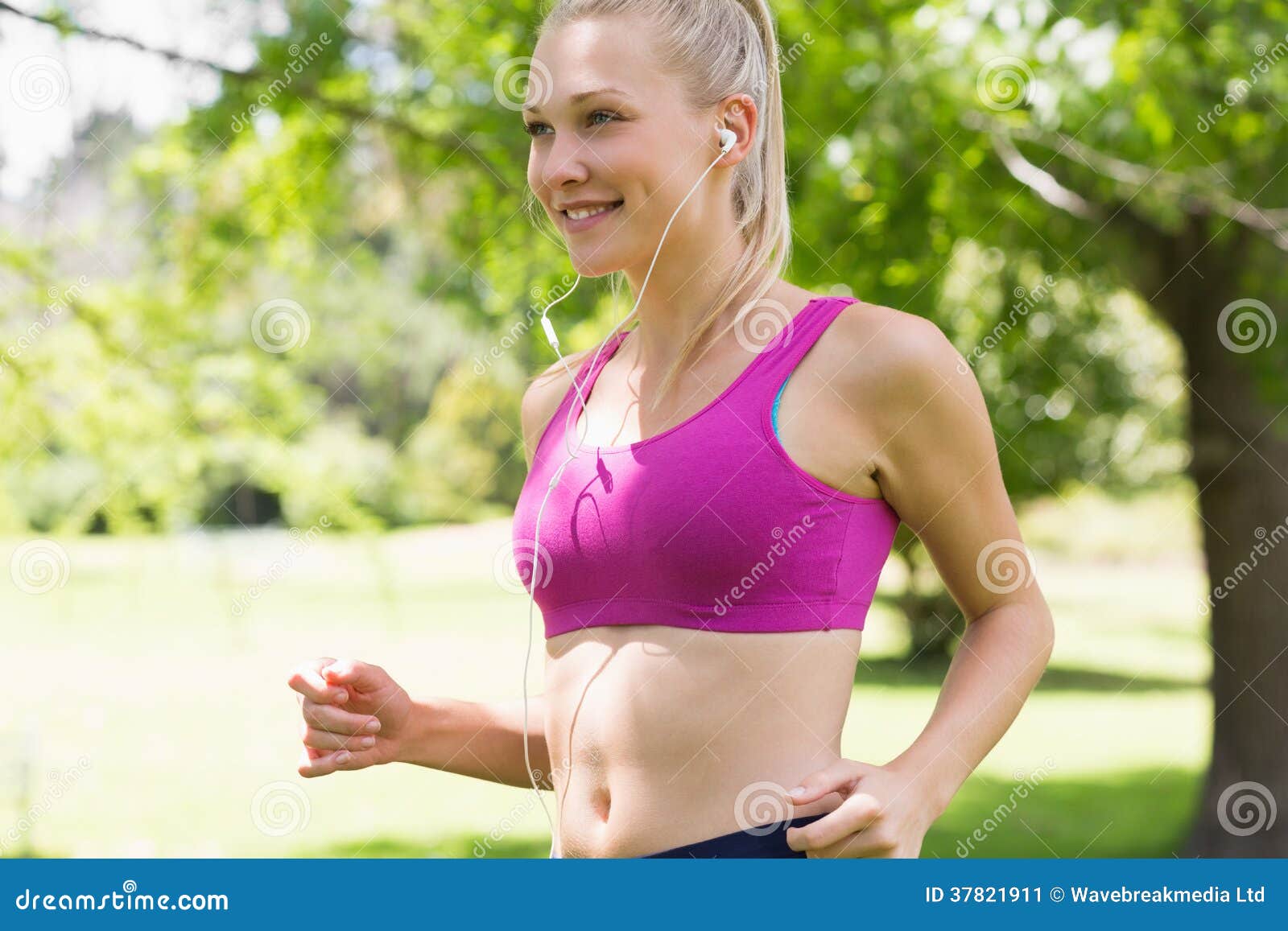 Healthy and Beautiful Young Woman in Sports Bra Jogging in Park