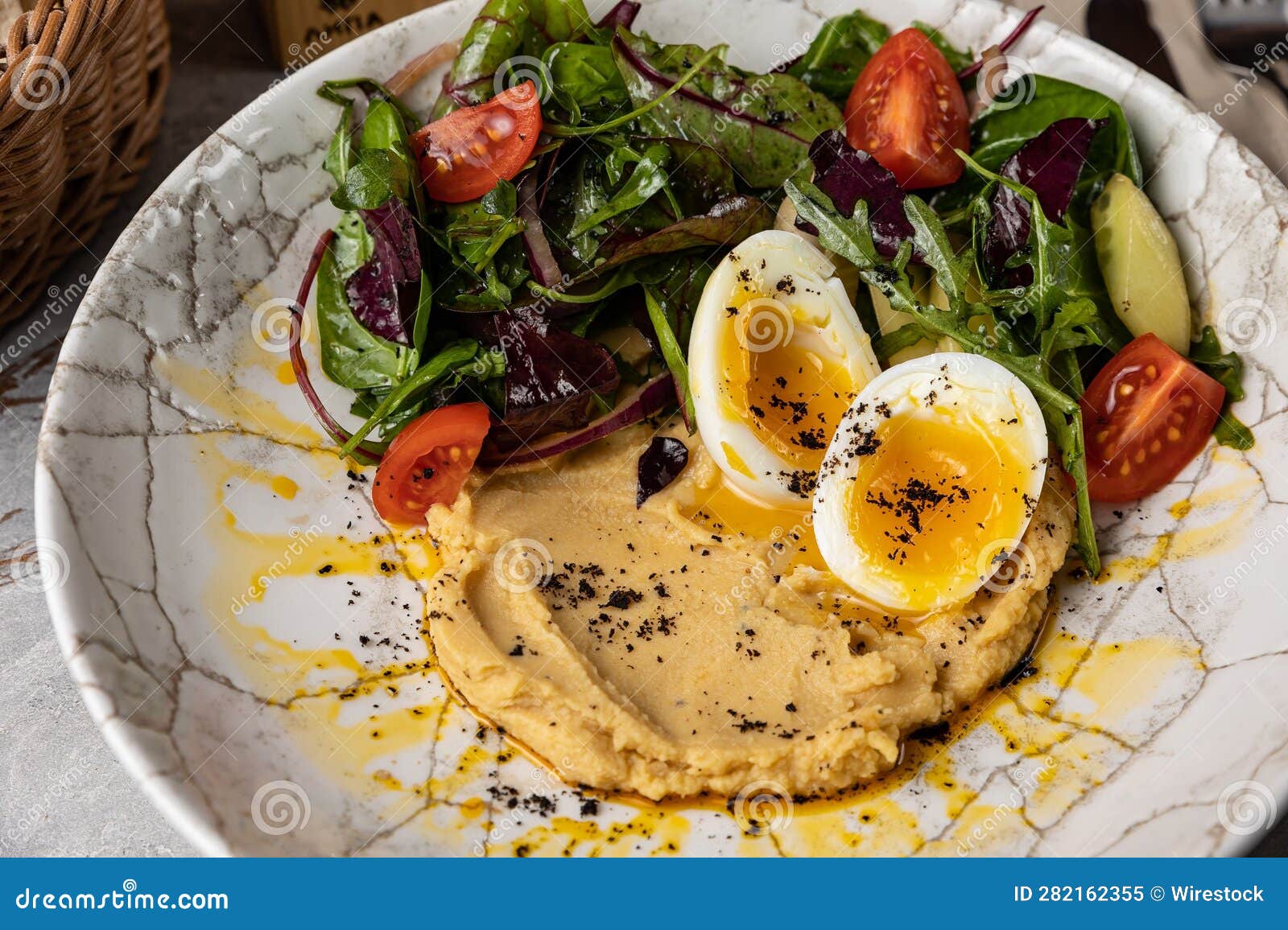 Healthy Bowl of a Fresh Breakfast Made with Hummus, Boiled Eggs and