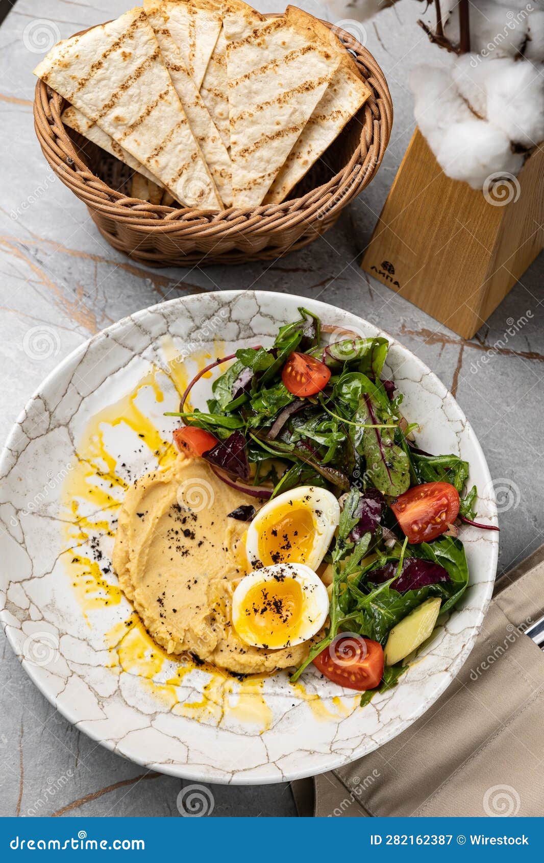 Healthy Bowl of a Fresh Breakfast Made with Hummus, Boiled Eggs and