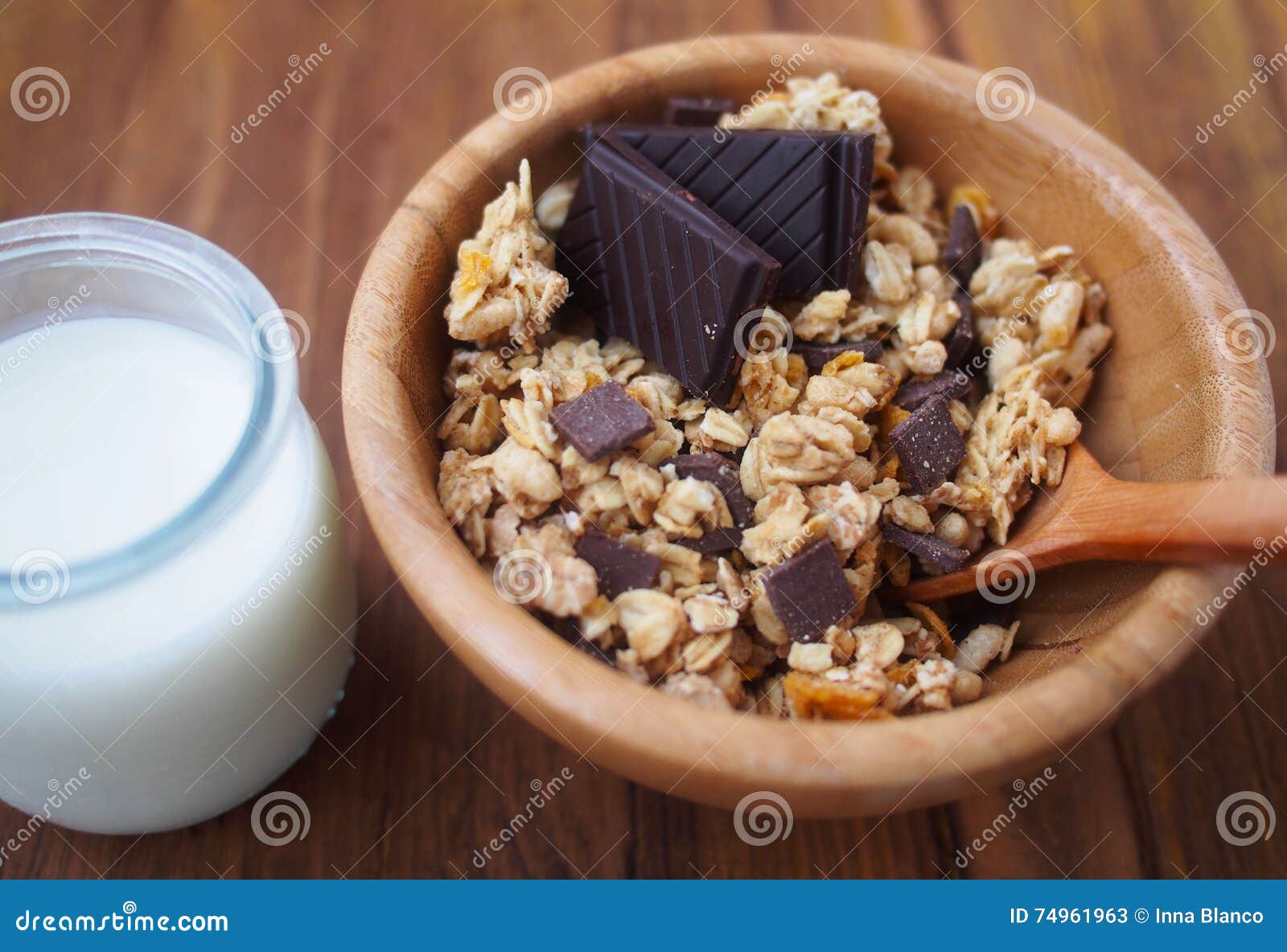 healthy breakfast - chocolate muesli in wooden bowl with fresh milk. spain