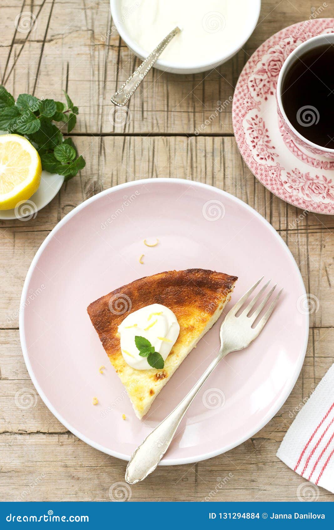 healthy breakfast made from soft cottage cheese casserole with oatmeal and lemon zest, served with sour cream and mint.
