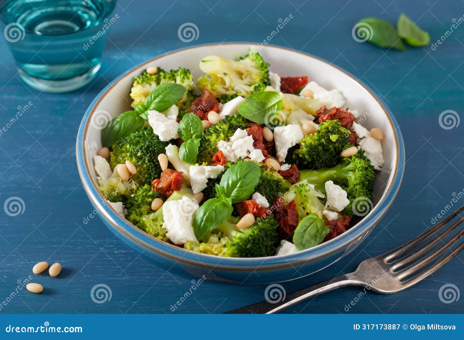 healthy broccoli salad with feta cheese sun dried tomatoes pine nuts.. vegetarian low carb keto diet