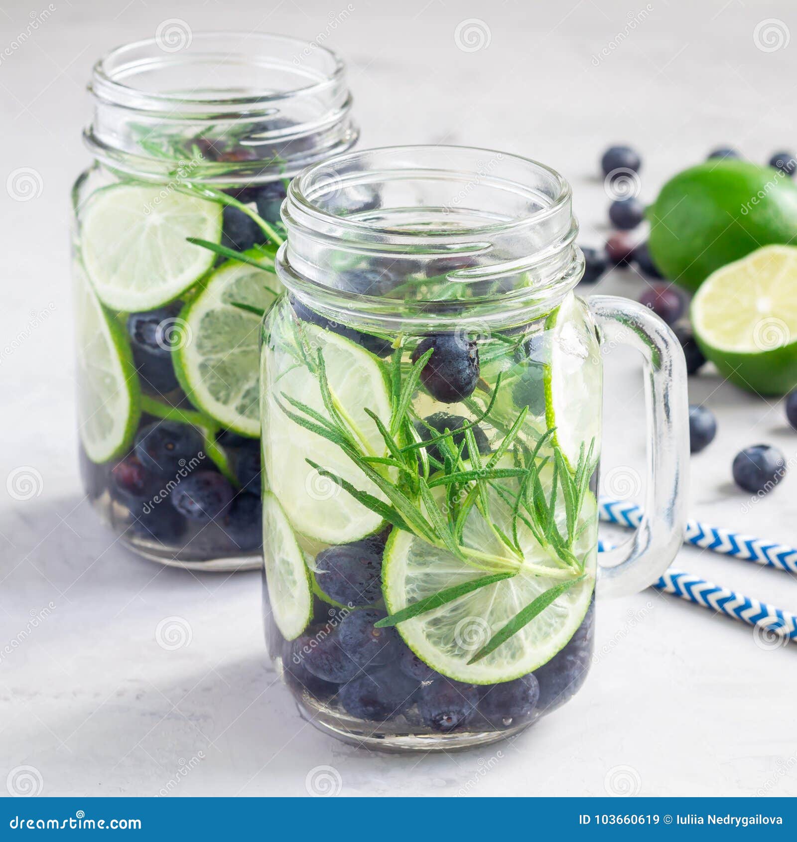 healthy cold infused water with fresh blueberry, lime and rosemary, square