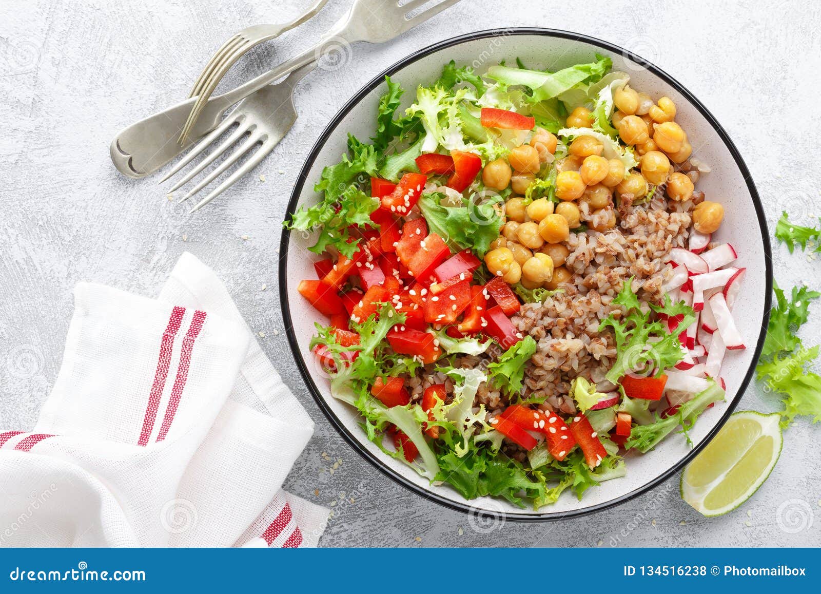 healthy and delicious bowl with buckwheat and salad of chickpea, fresh pepper and lettuce leaves. dietary balanced plant-based foo