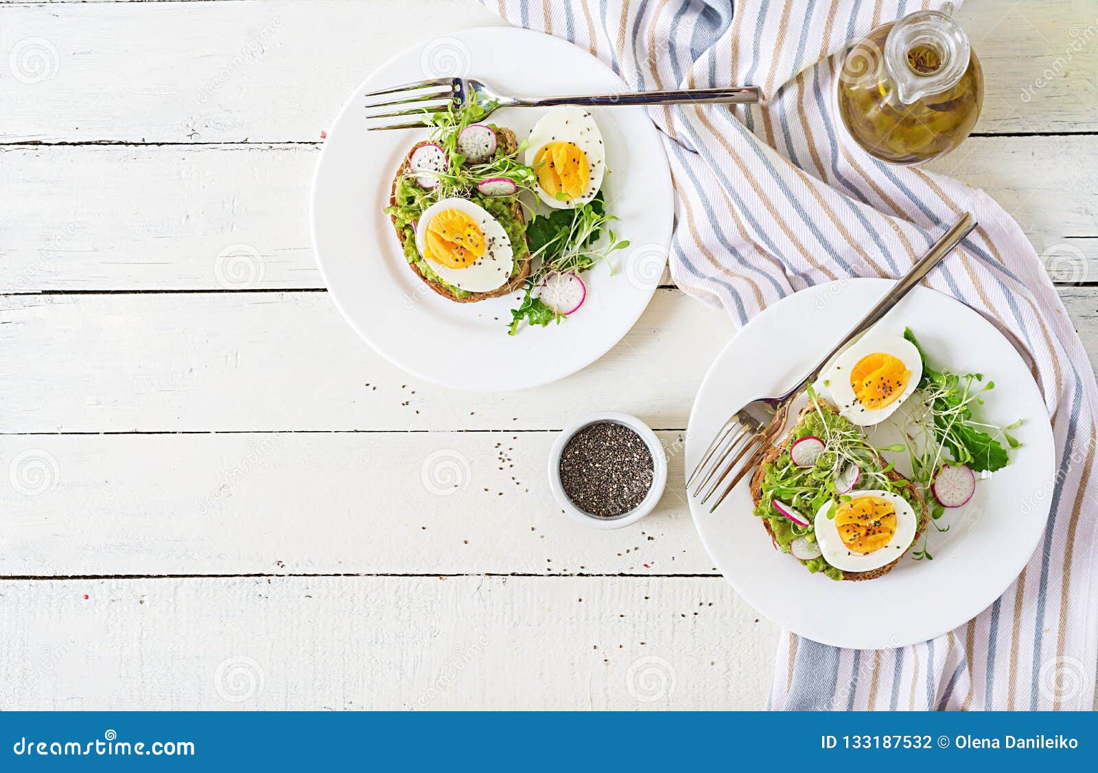 Avocado Egg Sandwich with Whole Grain Bread on White Wooden Background