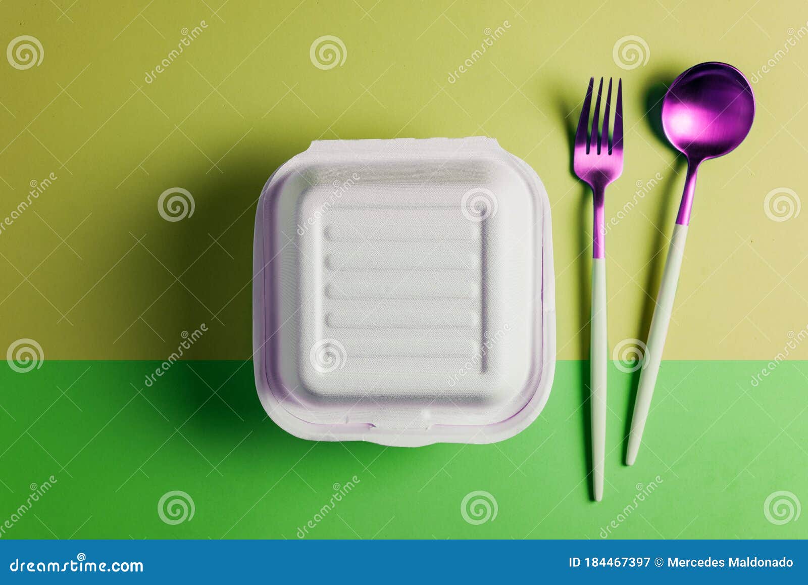 healthy food concept: white burguer packaging closed with retro fork and spoon